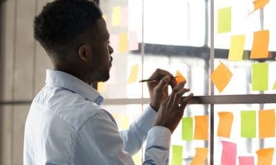 A Man Writing on Sticky Notes