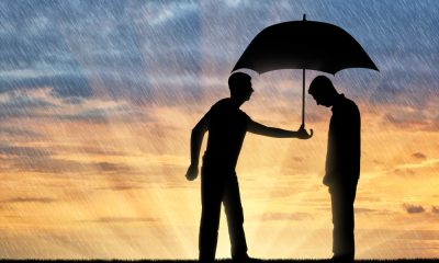 A Silhouette of Two Men with Umbrella