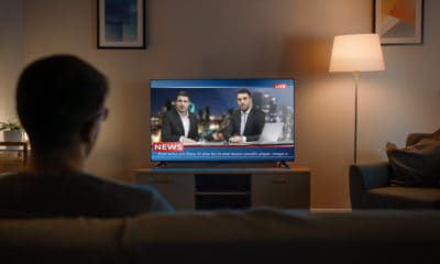 A Picture of a Person Watching News in the Living Room
