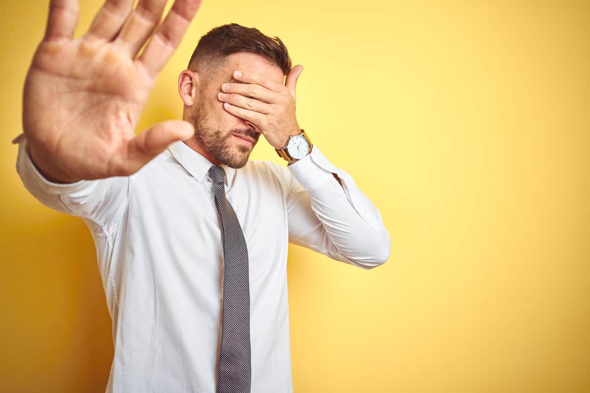 A Man Covering his Eyes