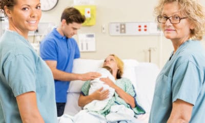 Hospital room new parents with newborn baby, midwives looking at you smiling. Midwife quotes