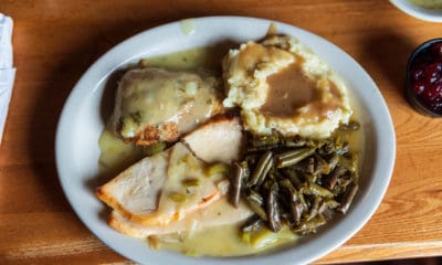 Cracker Barrel Thanksgiving: Plate of turkey breast, mashed potatoes, stuffing, and green beans smothered in gravy.
