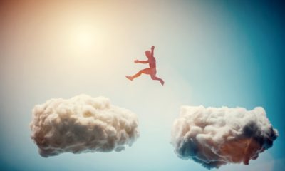 Man jumping from one cloud to another. Taking risks and challenge concept. Overcoming problems, winning.