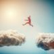 Man jumping from one cloud to another. Taking risks and challenge concept. Overcoming problems, winning.